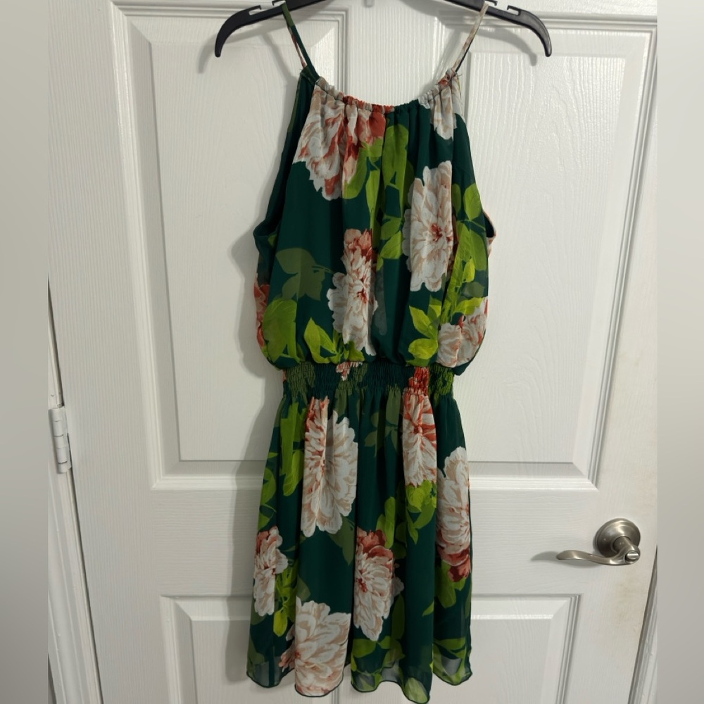 Mini black dress with white flowers and green leaves